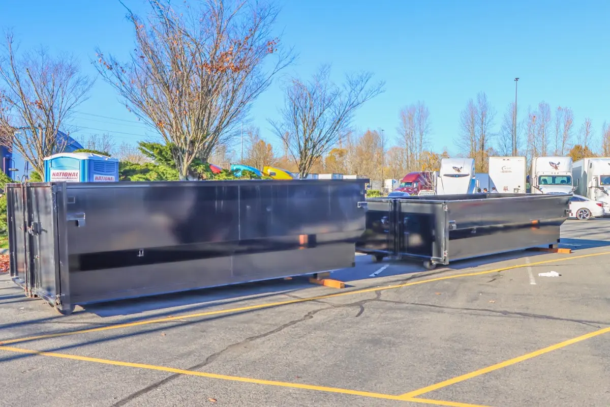 Professional dumpster rental service with roll-off container on residential driveway in Aledo